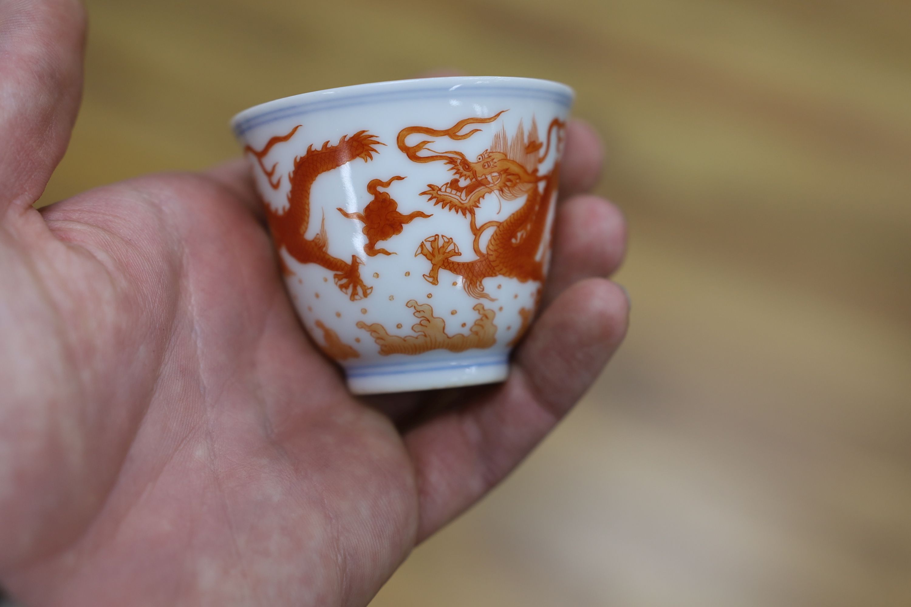 A Chinese iron red enamelled ‘dragon’ tea bowl, 5cm high